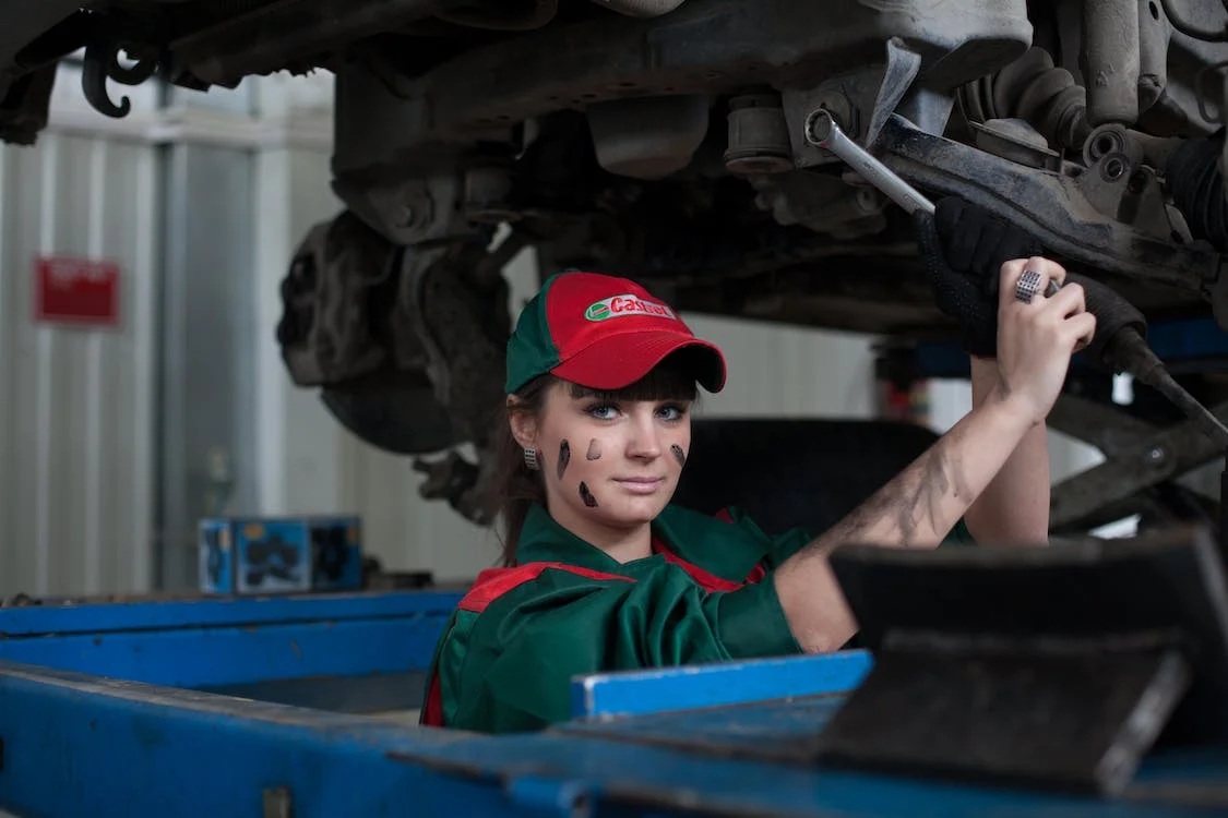 A female mechanic holding steel wrench